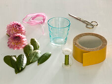 Dahlia flowers in glasses with rhododendron leaves (1/6)
