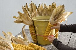 Bucket decorated with corncobs