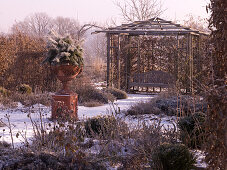 Winter rose garden with wooden pavilion