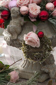 Gesteck aus Rosa (Rosen) und Christbaumkugeln in Steinvase