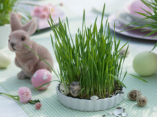 Easter table with Easter grass in cups and pots