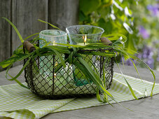 Lanterns in a wire basket with a bow made of Spartina (Golden Bar Grass)