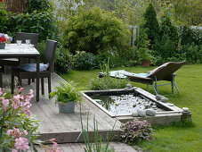 Build mini-pond out of flower bed with wooden border