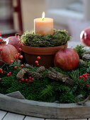 Candle in a clay pot with a moss-bark wreath