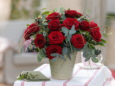 Winter bouquet made of red rose, eucalyptus, hedera