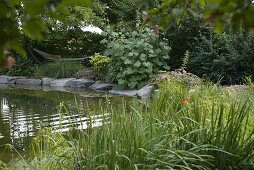 Garden pond bordered with granite blocks