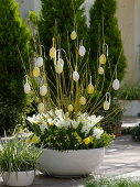 White-yellow planted bowl with dogwoods decorated for Easter