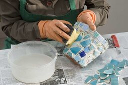 Glue clay pots with turquoise mosaic