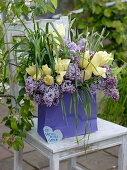 Fragrant bouquet of Syringa (lilac), Tulipa (tulips) and grasses