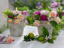 Rustic pots as candlesticks, decorated with pink flowers