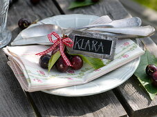 Sweet cherries with leaves and small slate