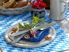 Bayrische Tischdeko: Holzbrett mit blauer Serviette