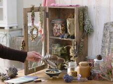 Small cupboard with dried herbs and smoking bundles