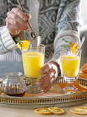 Hot orange juice in glass jars, orange pieces