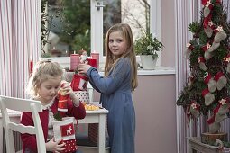 Girls unwrapping St. Nicholas presents