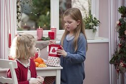 Mädchen packen Nikolaus-Geschenke aus