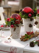 Weihnachtliche Tischdeko mit roten Kugel-Gestecken