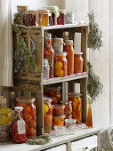Preserved tomatoes, hot peppers, vinegar and herbs in homemade shelf