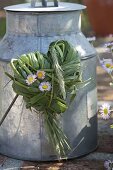 Heart of grasses and bellis (daisies) on old zinc pot