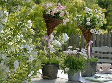 Homemade wicker baskets on sticks in metal pots