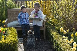 Children with Easter nest in farm garden