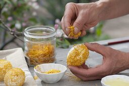 Sticking crushed flowers to easter eggs