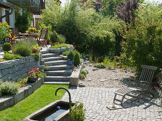 Hillside garden with granite wall terraced