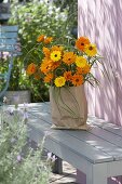 Bouquet of summer flowers in paper bag 2/2