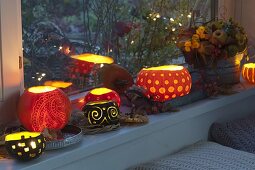 Window sill decorated with decorative carved pumpkins