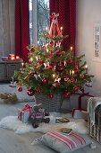 Living Nordmann fir decorated in red and white