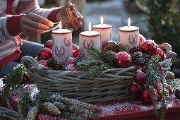 Advent basket with red balls, candles with deer decoration