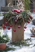 Wreath of Picea omorica with cones, decorated with red balls