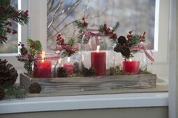 Unusual Advent wreath in preserving jars on wooden coasters