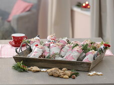 Advent calendar made of filled fabric socks on wooden tray