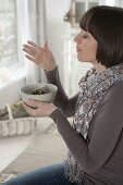 Woman smoking herbs in herb bowl