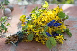 Blue-yellow spring bouquet with forsythia (goldbells)