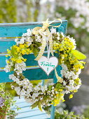 White-yellow spring wreath on the back of a chair