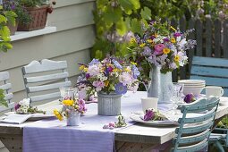 Summer table decoration with Rosa (roses), Scabiosa (widow flowers), Campanula