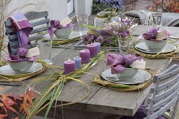 Autumn table decoration with grasses, heather and chrysanthemum flowers