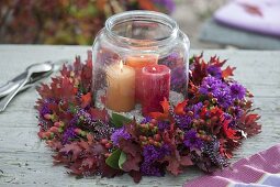 Autumn wreath with purple cushion aster and red foliage