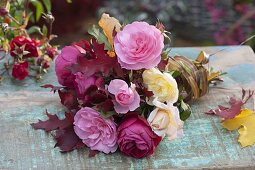 Bouquet of pink (rose) and colorful autumn leaves