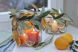 Canning jars as lanterns at the window, decorated with twigs of olea