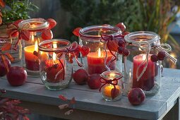 Old preserving jars as lanterns with home-made lanterns made from candle remains