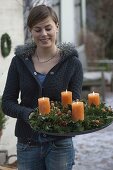 Woman with natural advent wreath of Abies nordmanniana