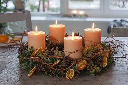 Tie Advent wreath from mixed greenery