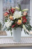 Winter bouquet with Hippeastrum 'White Peacock', 'Hummingbird Red' (Amaryllis), pink