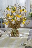 Standing bouquet of willow with eggshells as vases