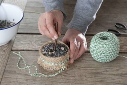 Birdseed in different containers to hang up