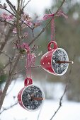 Birdseed in different hanging containers