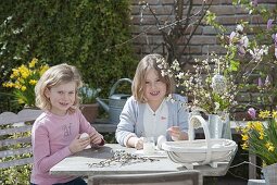 Children making and painting Easter eggs